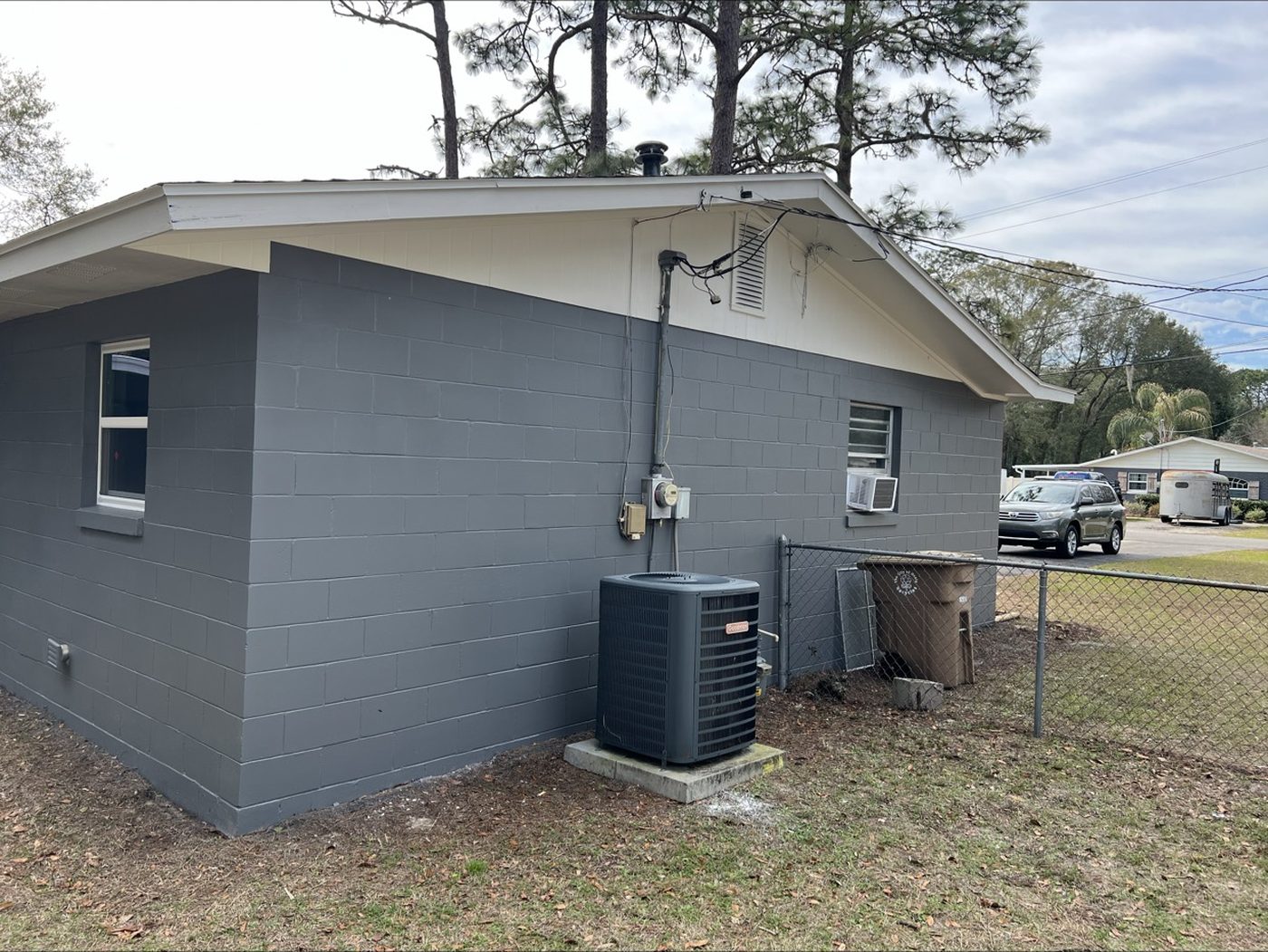 After: repainted exterior corner in dark gray with new AC unit