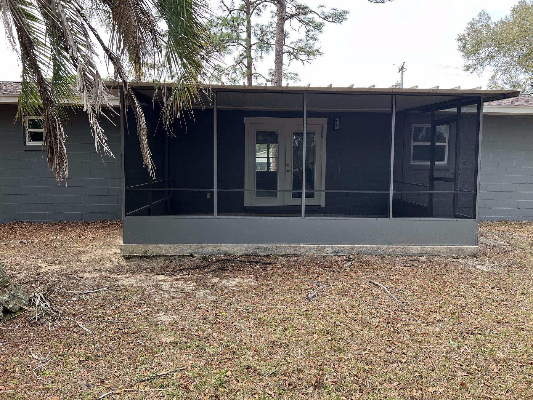 Freshly painted home exterior with screened front porch