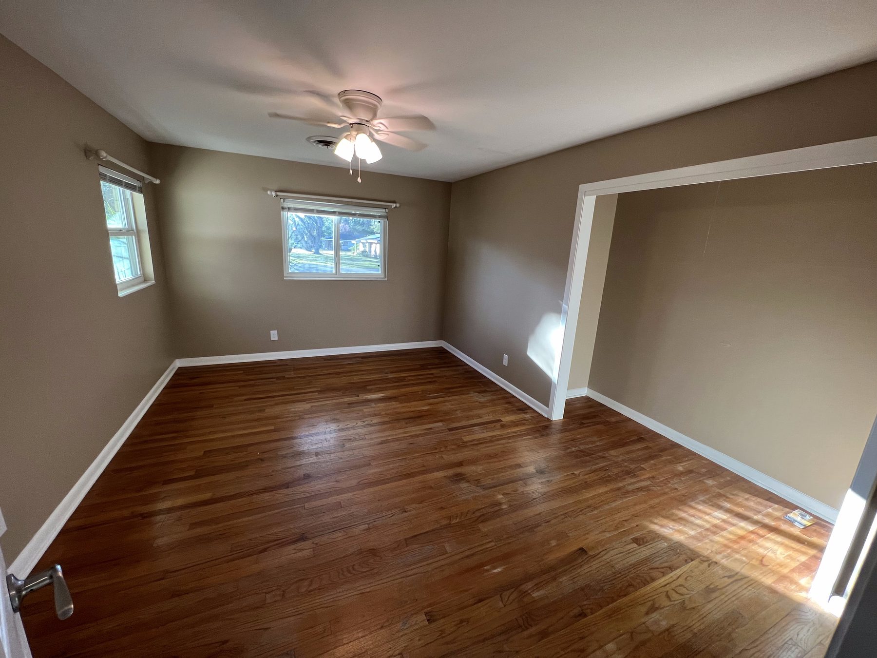 Bright, freshly painted room with hardwood floors