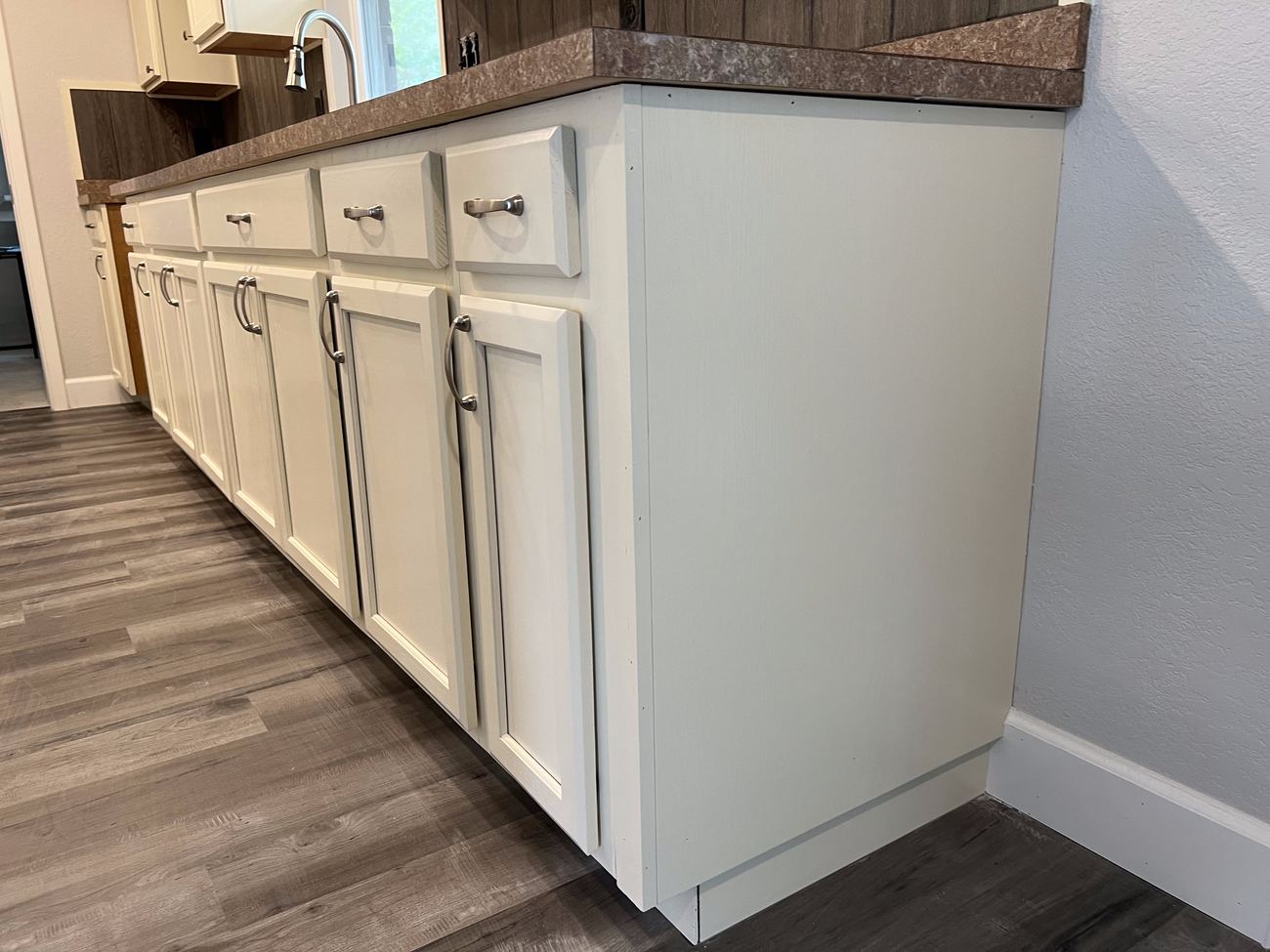 Refinished white kitchen cabinetry with a smooth, hand-finished sheen