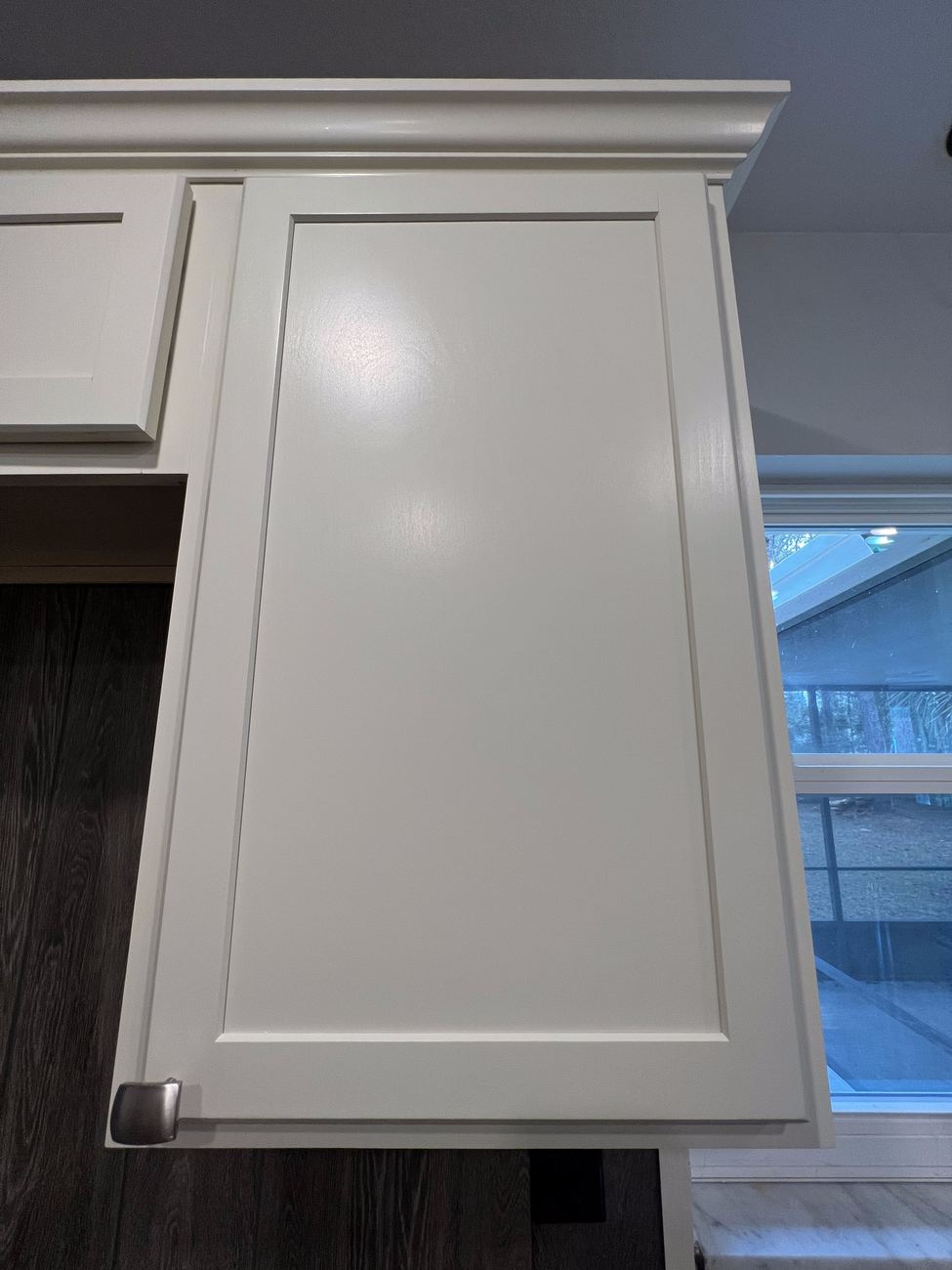 Detail of a hand-finished cabinet door with a glass-smooth painted finish